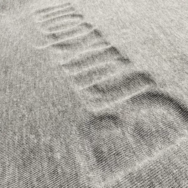 image of the inside of a sweatshirt that has been screen printed with puff ink showing the indentation of the printed image
