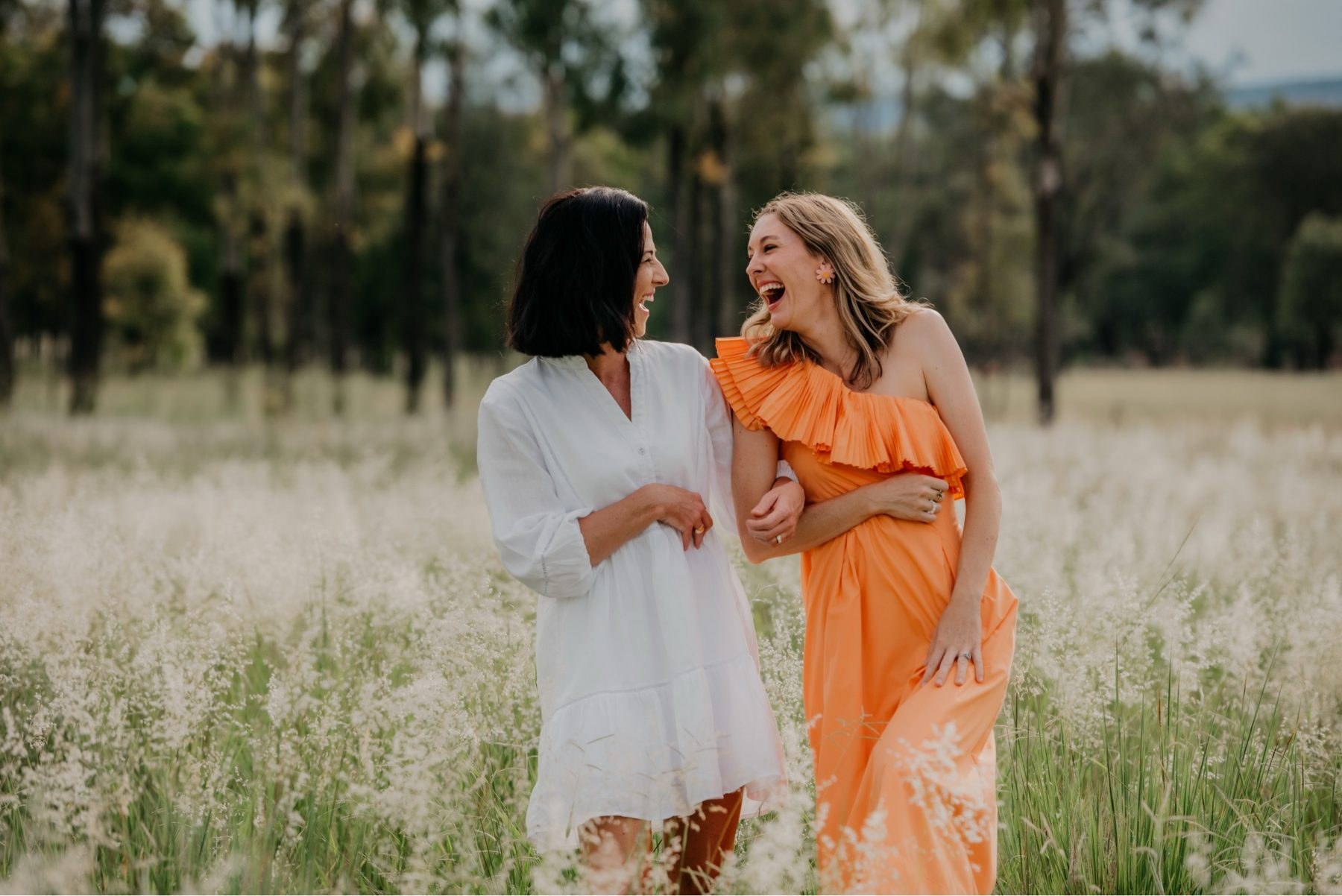 Caitlyn and Annie walking through grassland