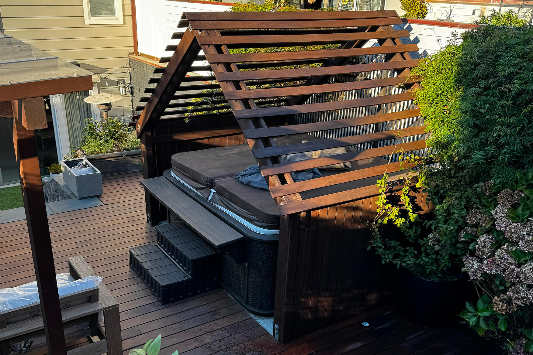 Custom cedar lattice privacy structure over a backyard hot tub, integrated into a composite deck in the San Francisco Bay Area.