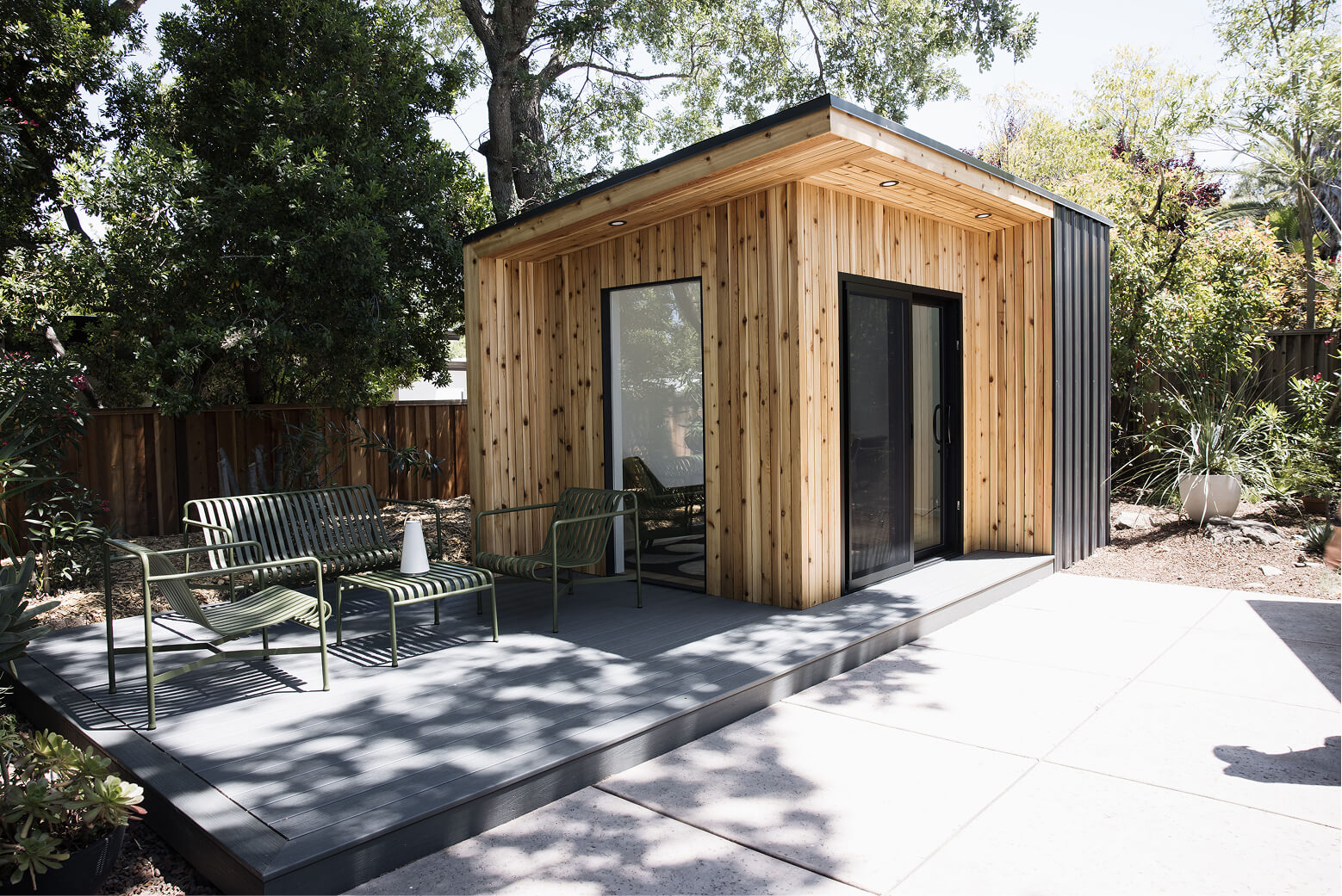 Front view of the Monterey custom backyard shed with wood siding and modern entrance