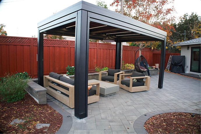 Custom aluminum pergola with integrated LED lighting, creating a modern outdoor living space in a California backyard.