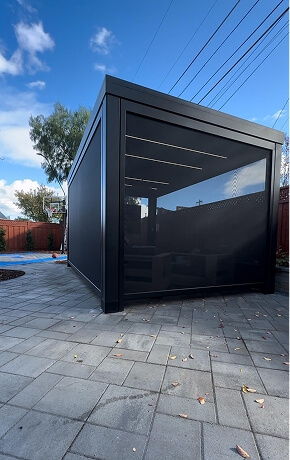 Modern aluminum pergola with motorized retractable screens and LED lighting for outdoor living in the San Francisco Bay Area.