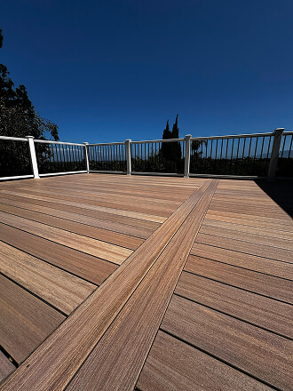 Modern composite deck with white railings overlooking the landscape.