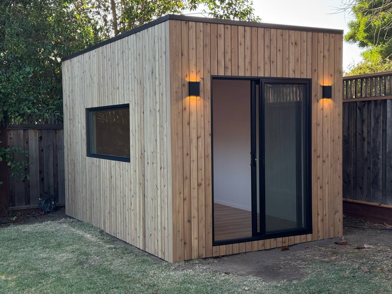 Modern Cube backyard studio featuring cedar cladding, black aluminum windows, and a minimalist design