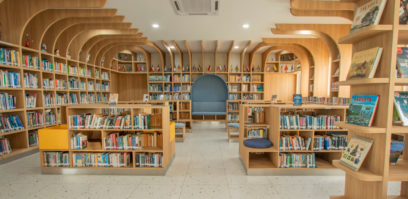 Picture of the Sekolah Bogor Raya Library. Beautiful, newly renovated, with many books and nationality flags.