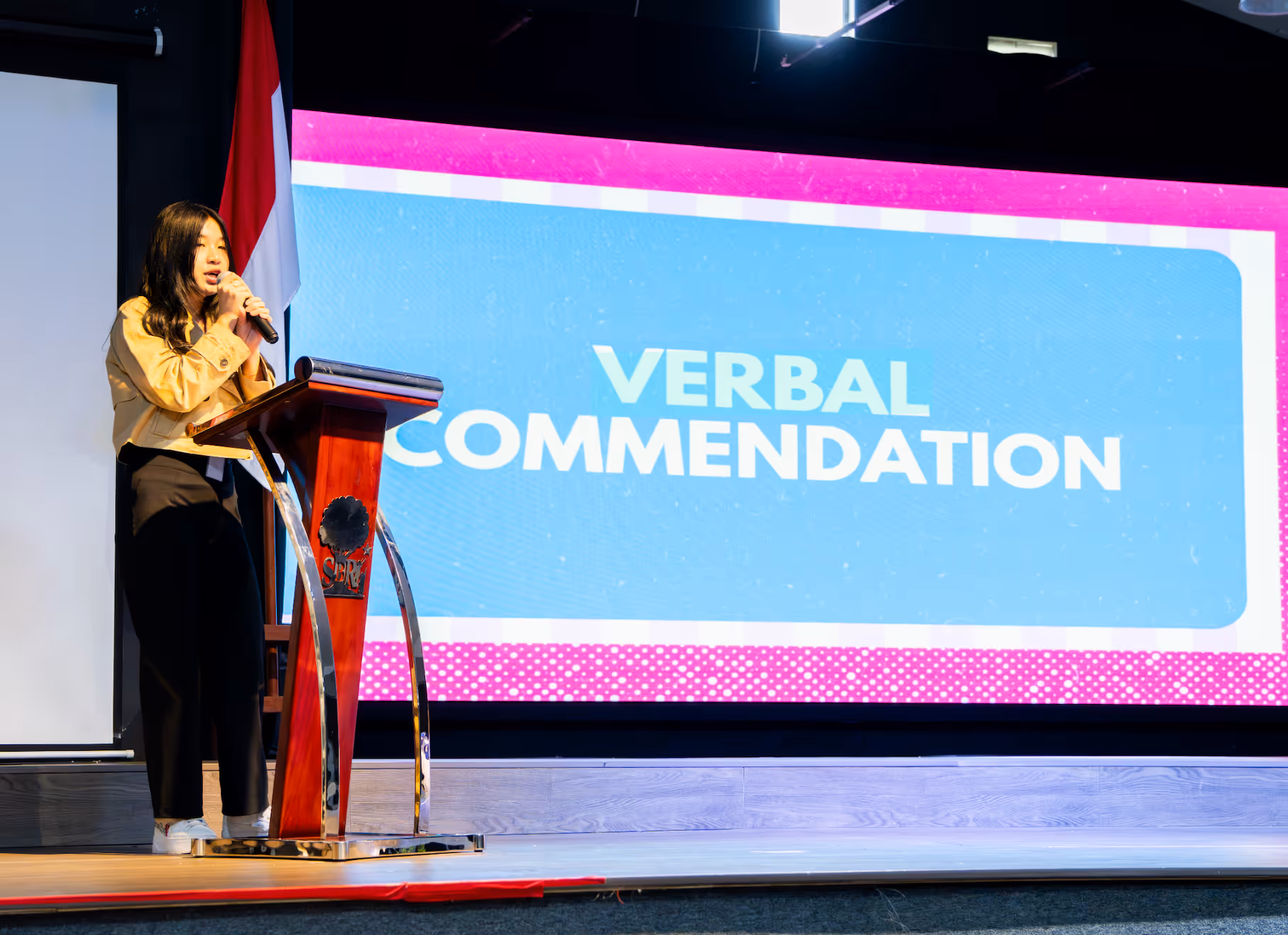 Sekolah Bogor Raya student on stage talking for Model United Nations. 