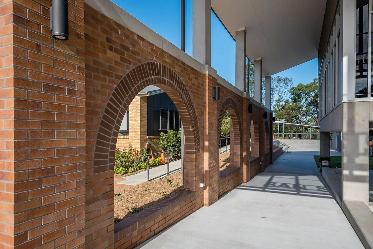 Brick archway walkway at a commercial construction project completed by a Brisbane electrical contractor.