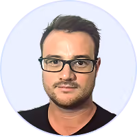 Portrait of a man with short dark hair, beard, and black glasses wearing a black shirt against light background.