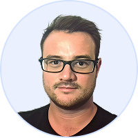 Portrait of a man with short dark hair, beard, and black glasses wearing a black shirt against light background.
