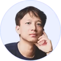 Portrait of a young man resting his chin on his hand with a thoughtful expression.