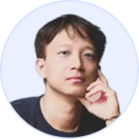 Portrait of a young man resting his chin on his hand with a thoughtful expression.