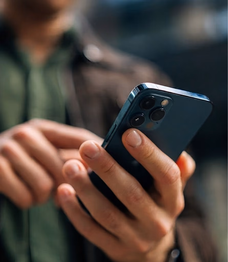Close-up of hands holding a smartphone.