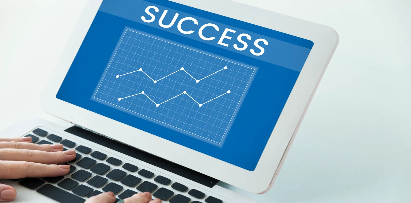 Worth Recruiting Toronto. Laptop screen displaying the word 'SUCCESS' above two line graphs with data points, with hands typing on the keyboard.