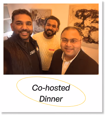 Three men smiling indoors with abstract paintings on the wall, above text reading 'Co-hosted Dinner'.