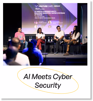 Panel discussion with four speakers on stage at Venture Cafe Berlin event about AI and cybersecurity with audience in foreground.
