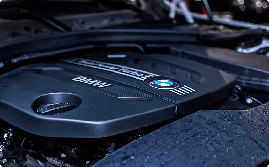 Close-up of a BMW engine cover labeled with TwinPower Turbo and BMW logos.