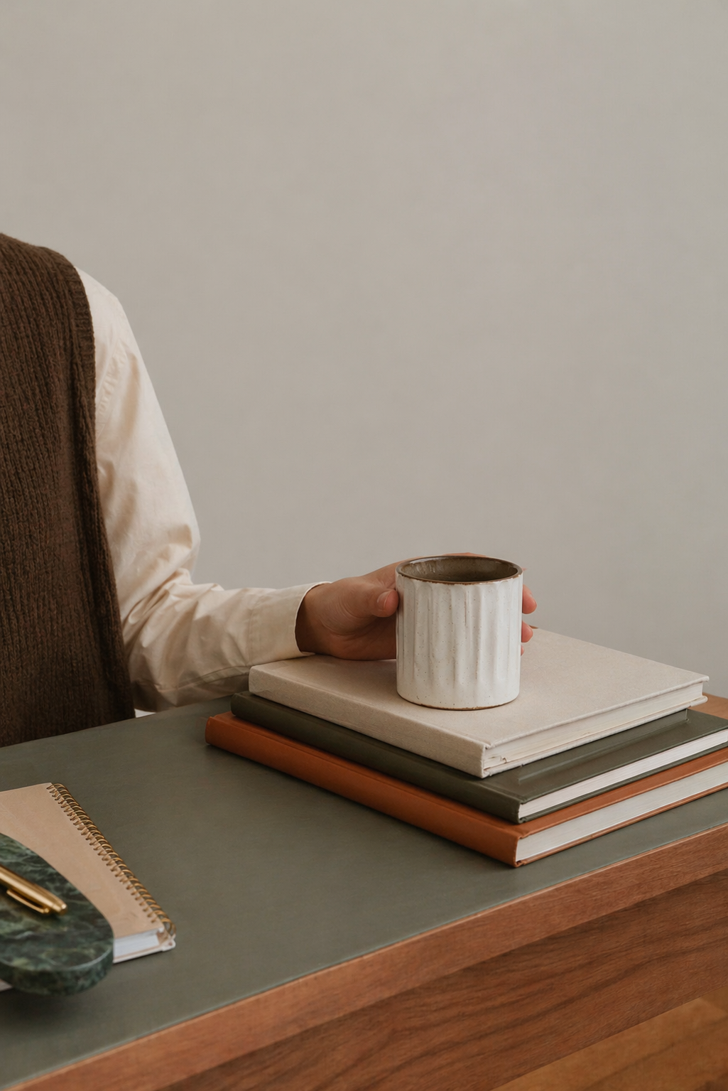Pause café studieuse sur un bureau en bois massif dans un logement Anchor, alliant confort et travail.