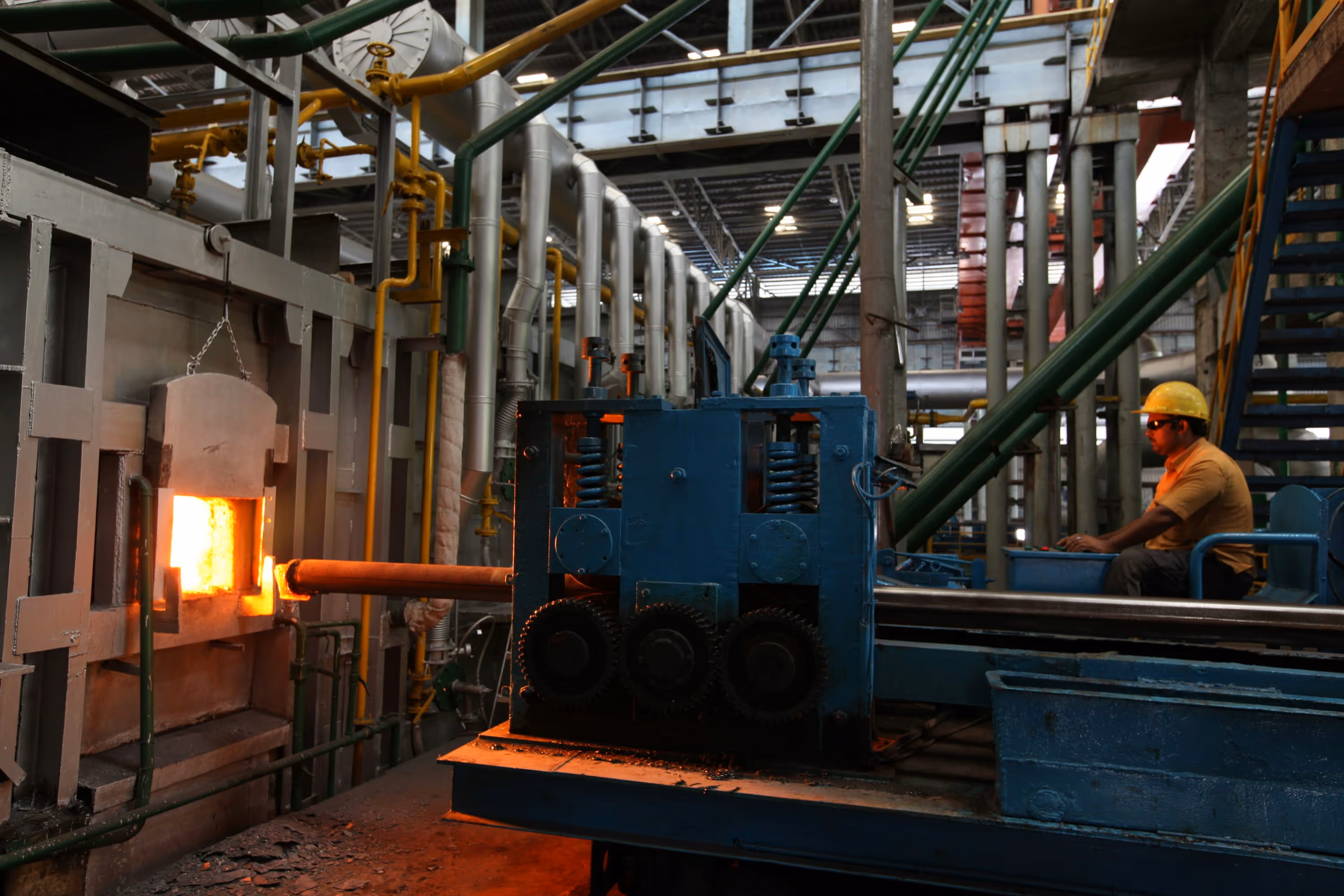 A man in a factory working on a piece of machinery