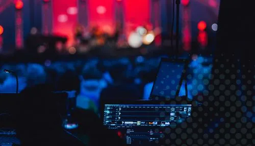 a crowd of people sitting in front of a stage