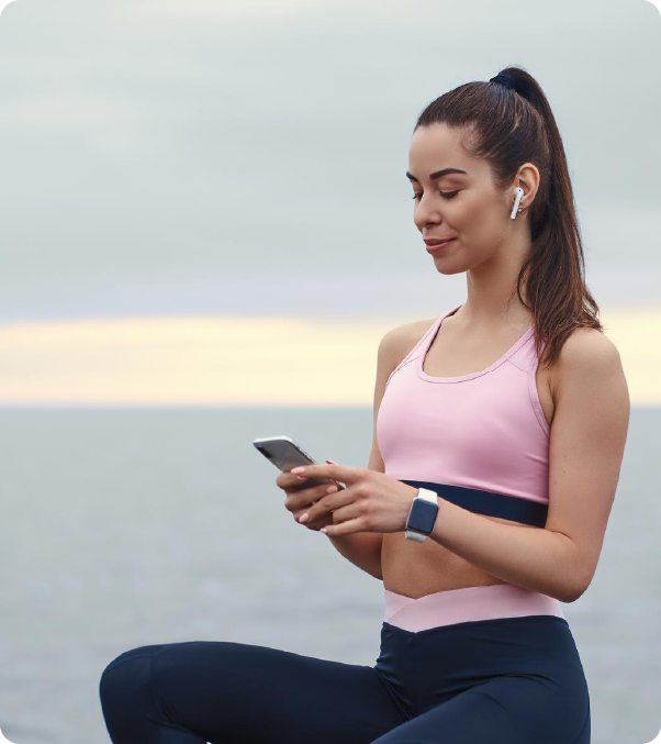 Person with short blonde hair wearing a dark oversized sweatshirt, holding a phone to their ear with glowing rings circling around their head.