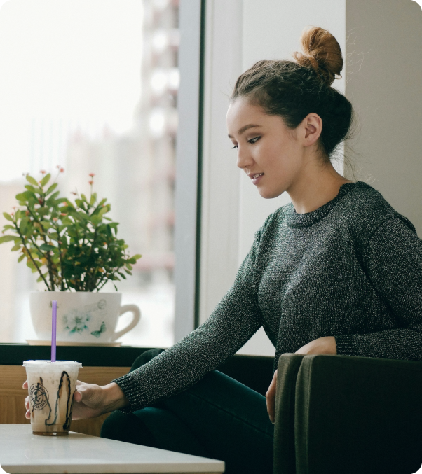 Portrait of a woman in a teal jacket with a blurred, glowing orange visor obscuring her eyes and extended back with motion blur effect.