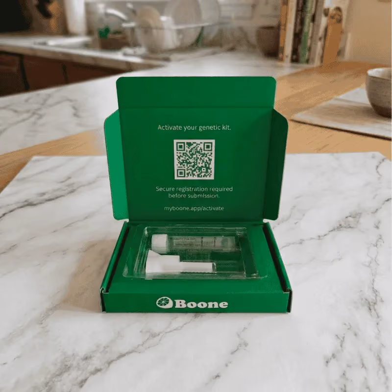 Opened Boone DNA kit with saliva collection tube and activation QR code