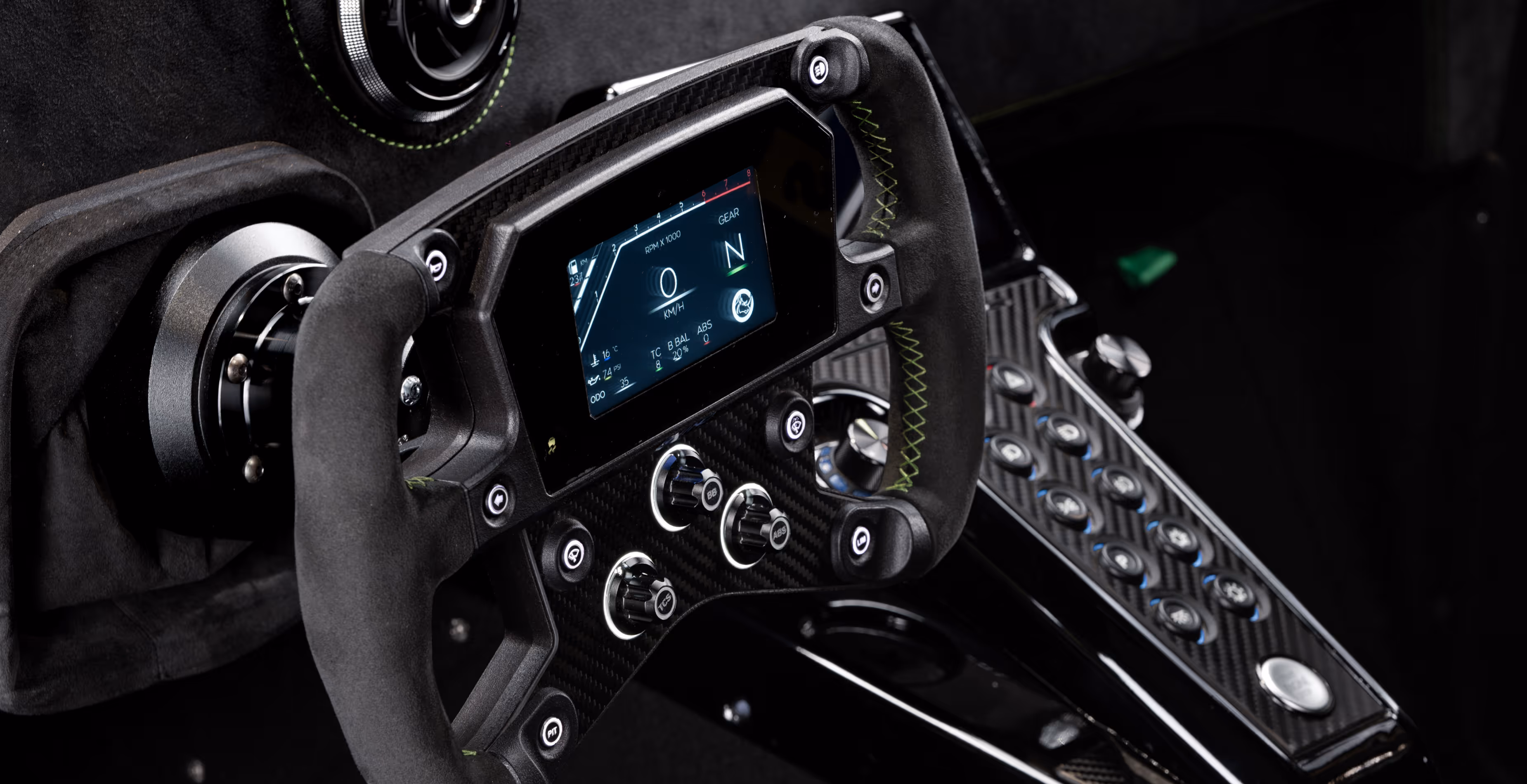 Close-up of the RR01 steering wheel on carbon dashboard