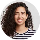 Smiling young woman with curly hair wearing a striped shirt against a transparent background.