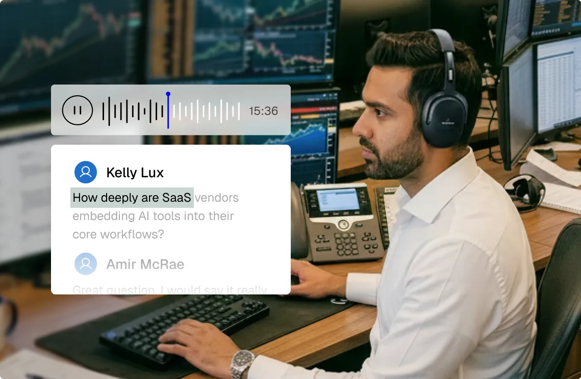 Man wearing headphones working at a desk with multiple monitors displaying financial charts and data.