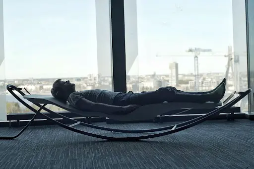 A person using the Stapes vibroacoustic bed