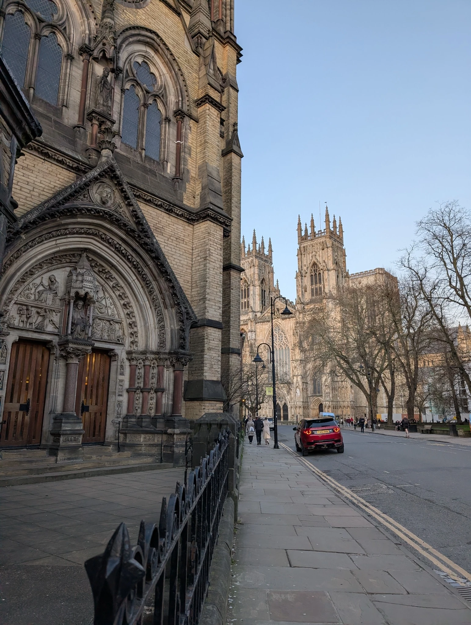 A picture of St Wilfred's Church and York Minster on a sunny evening