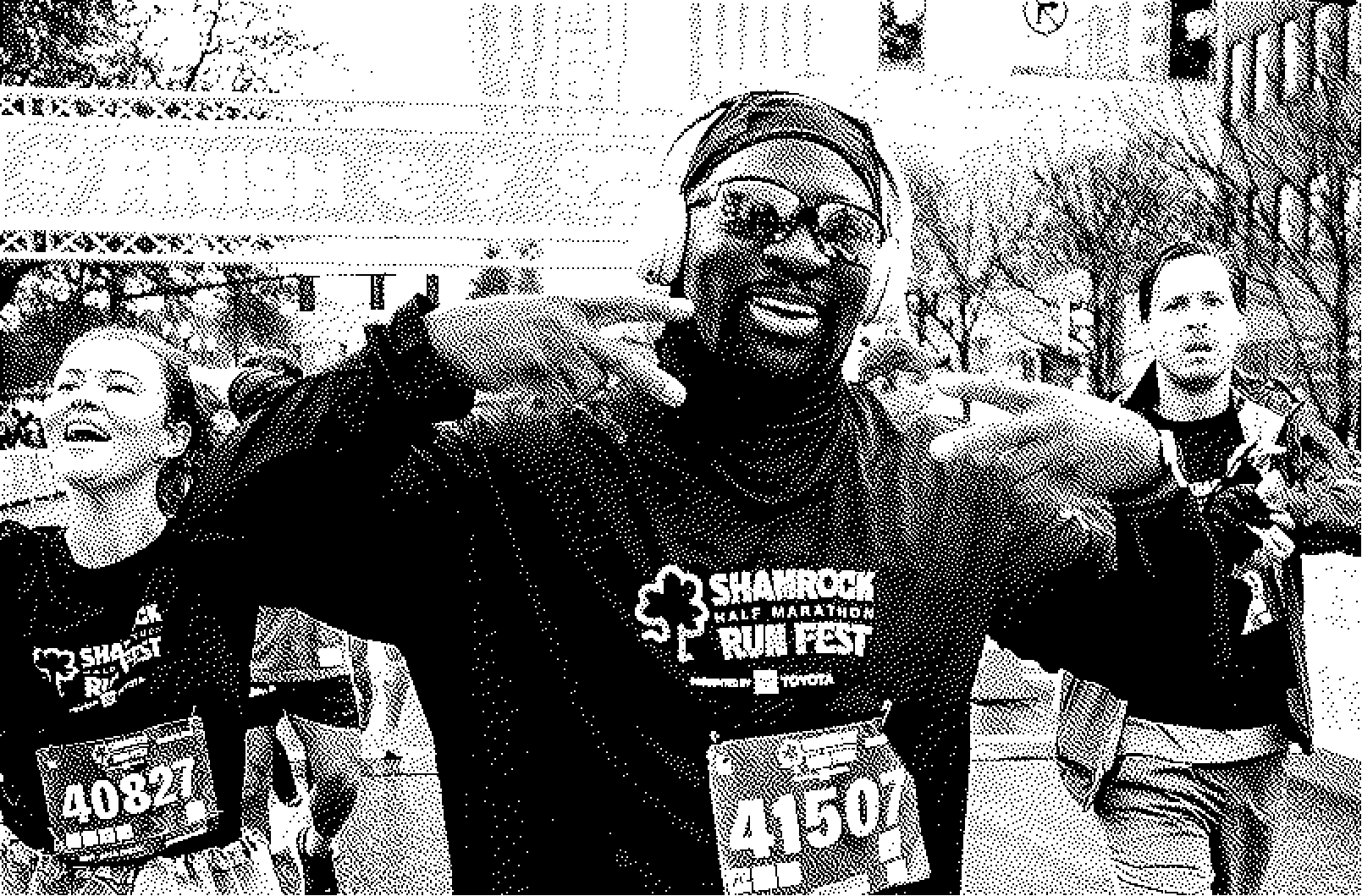 Smiling male runner wearing sunglasses and headphones making peace signs, participating in the Shamrock Half Marathon Run Fest.