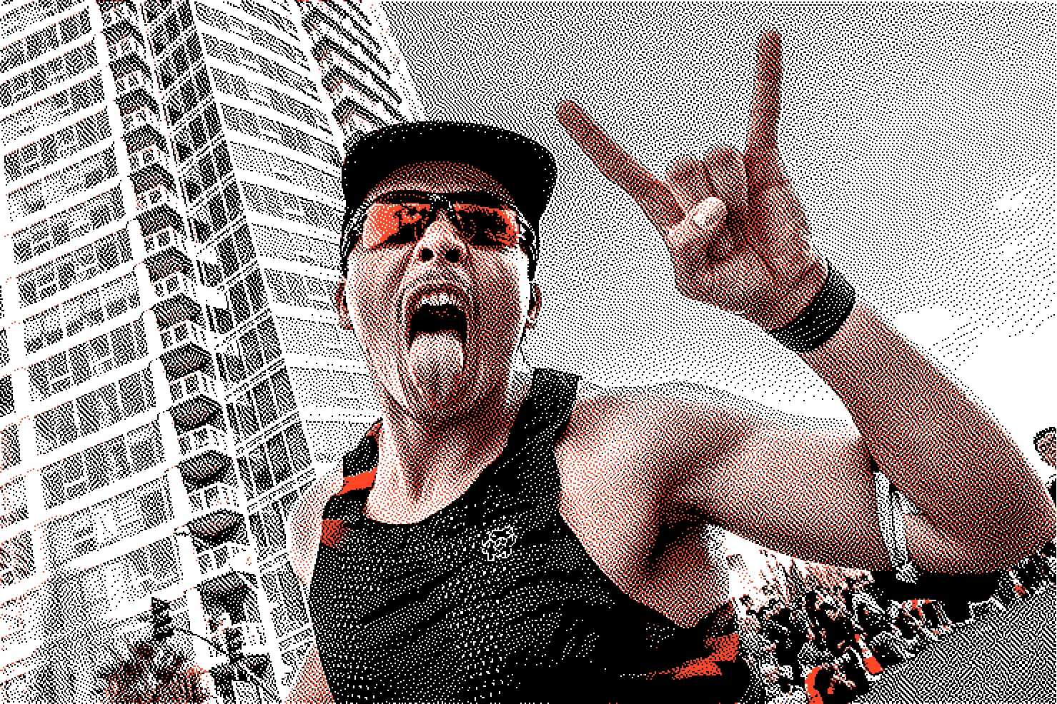 Energetic male marathon runner wearing sunglasses and a cap, making a rock and roll hand gesture with his tongue out at the Long Beach Marathon.