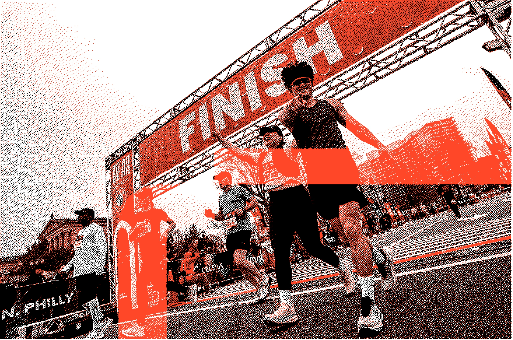 Runners celebrating as they cross the finish line of a race with a large 'FINISH' banner overhead.