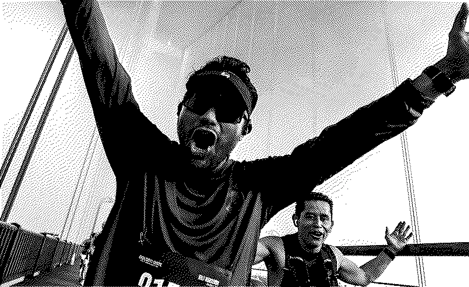 Two male runners celebrating energetically during a marathon on the golden gate bridge.