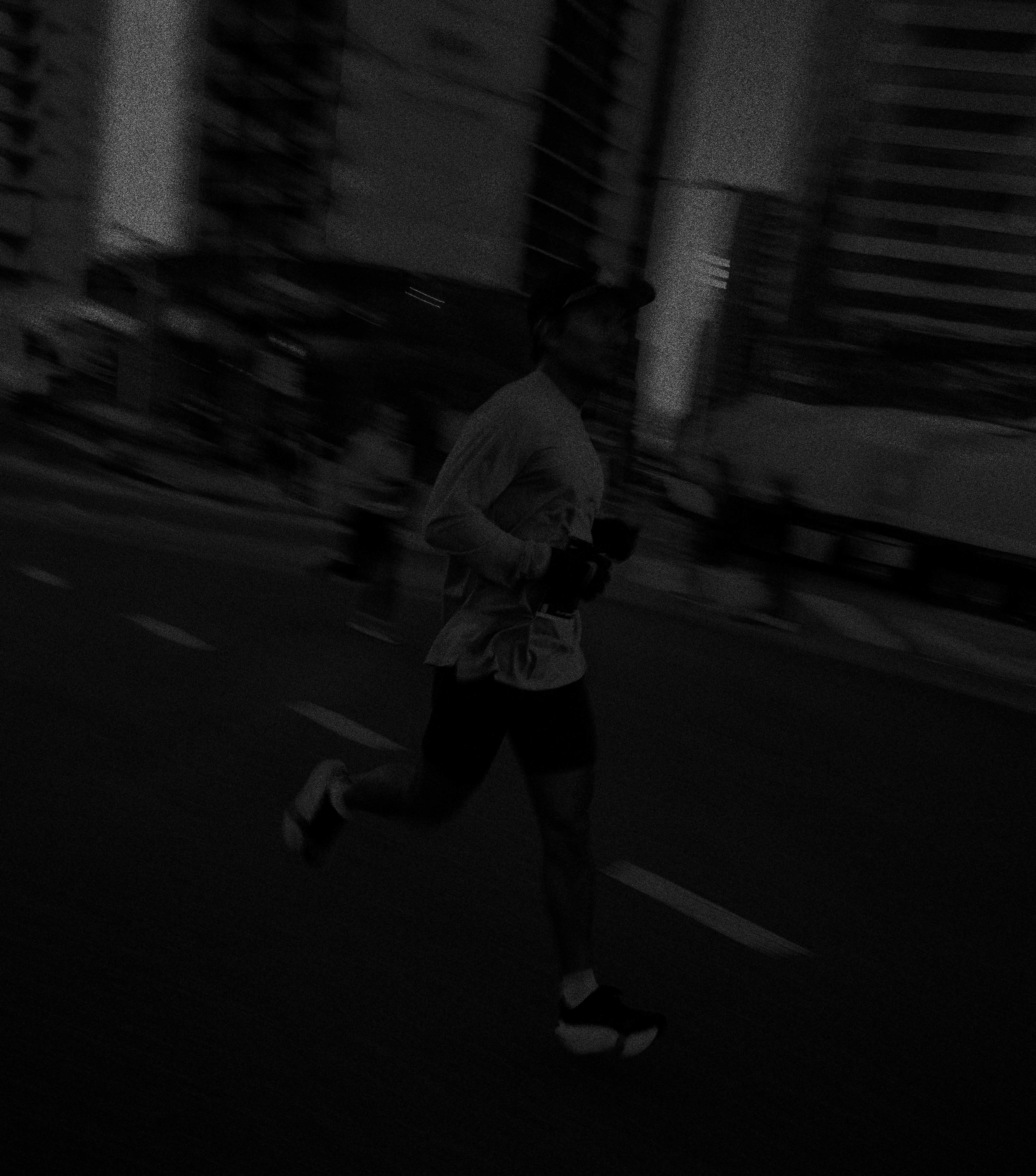 I edgy image of a runner blurry running through the city 