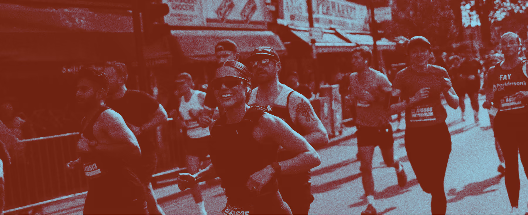 WOMAN SMILING WHILE RUNNING A RACE WITH A RED AND GRAINY TEXTURE OVER THE IMAGE
