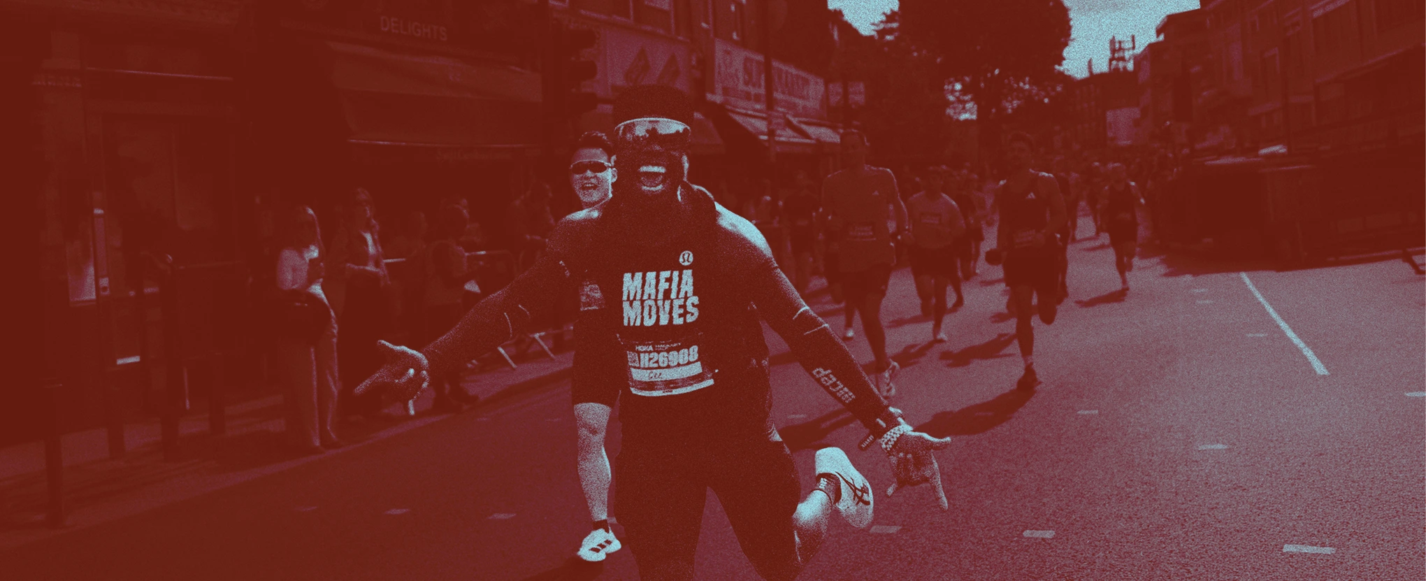 Man running excitingly along the streeets in Shoreditch during Shoreditch 10K