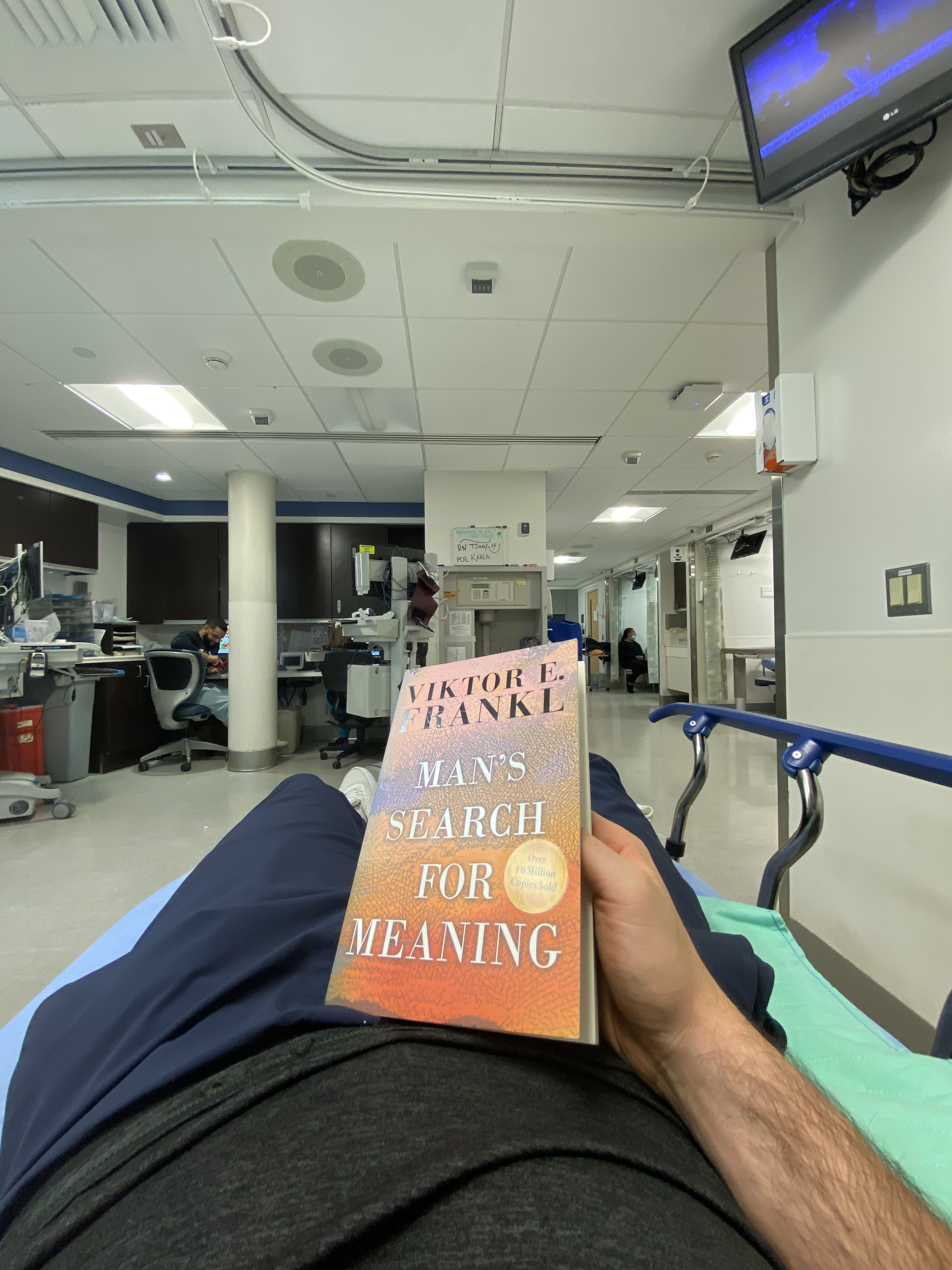 Oren reading Viktor Frankl's 'Man's Search for Meaning' from a hospital bed