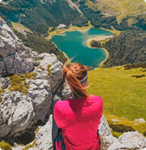 Hiker enjoying panoramic view of Trnovačko glacial lake, Sutjeska National Park Bosnia