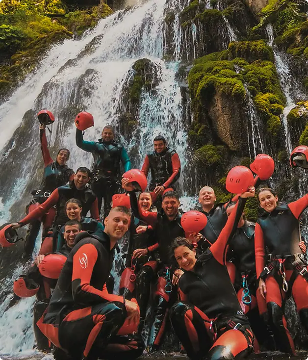 Excited group with local guides after completing Hrčavka canyoning adventure, Sutjeska National Park Bosnia