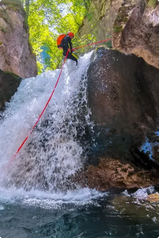 Professional canyoning guide descending Hrčavka canyon on rope, Sutjeska National Park Bosnia and Herzegovina