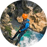 Lead guide leaning down looking for route, canyoning Hrcavka