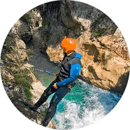 Lead guide leaning down looking for route, canyoning Hrcavka