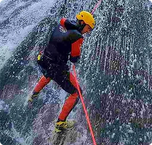 Certified ICOpro guide rappelling down Hrčavka canyon waterfall going down, expert canyoning Bosnia