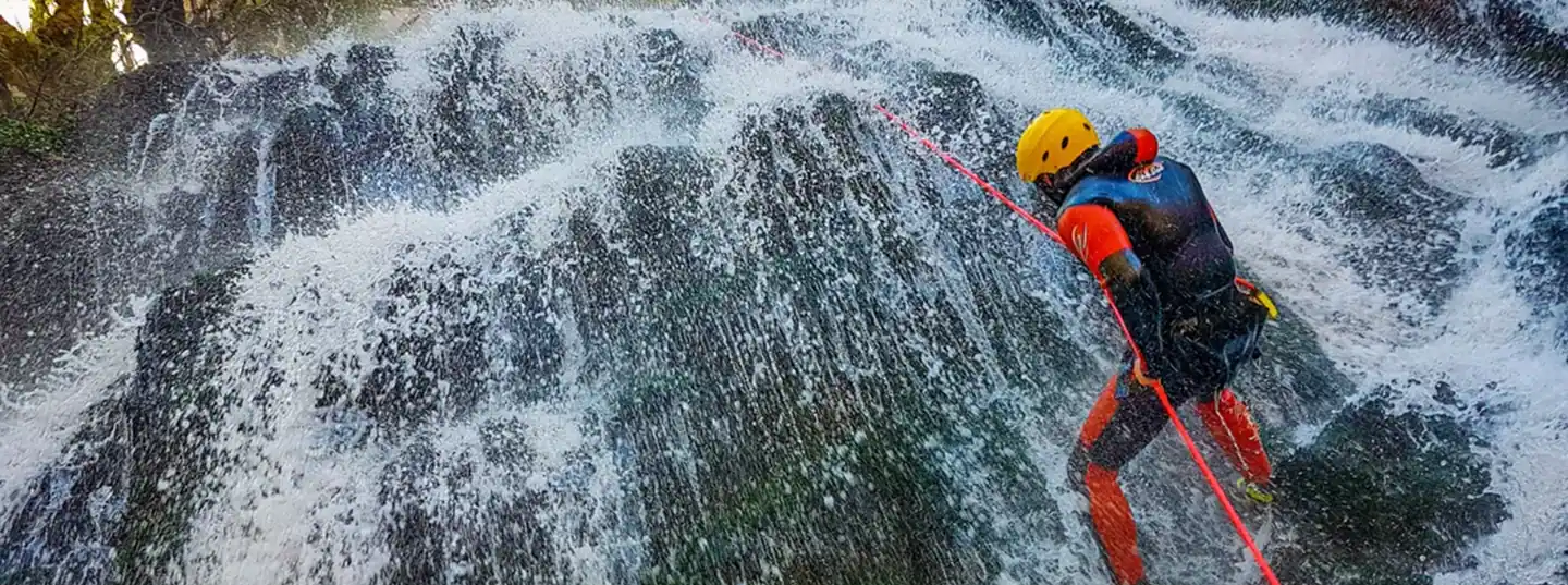 Certified ICOpro guide rappelling down Hrčavka canyon waterfall, expert canyoning Bosnia