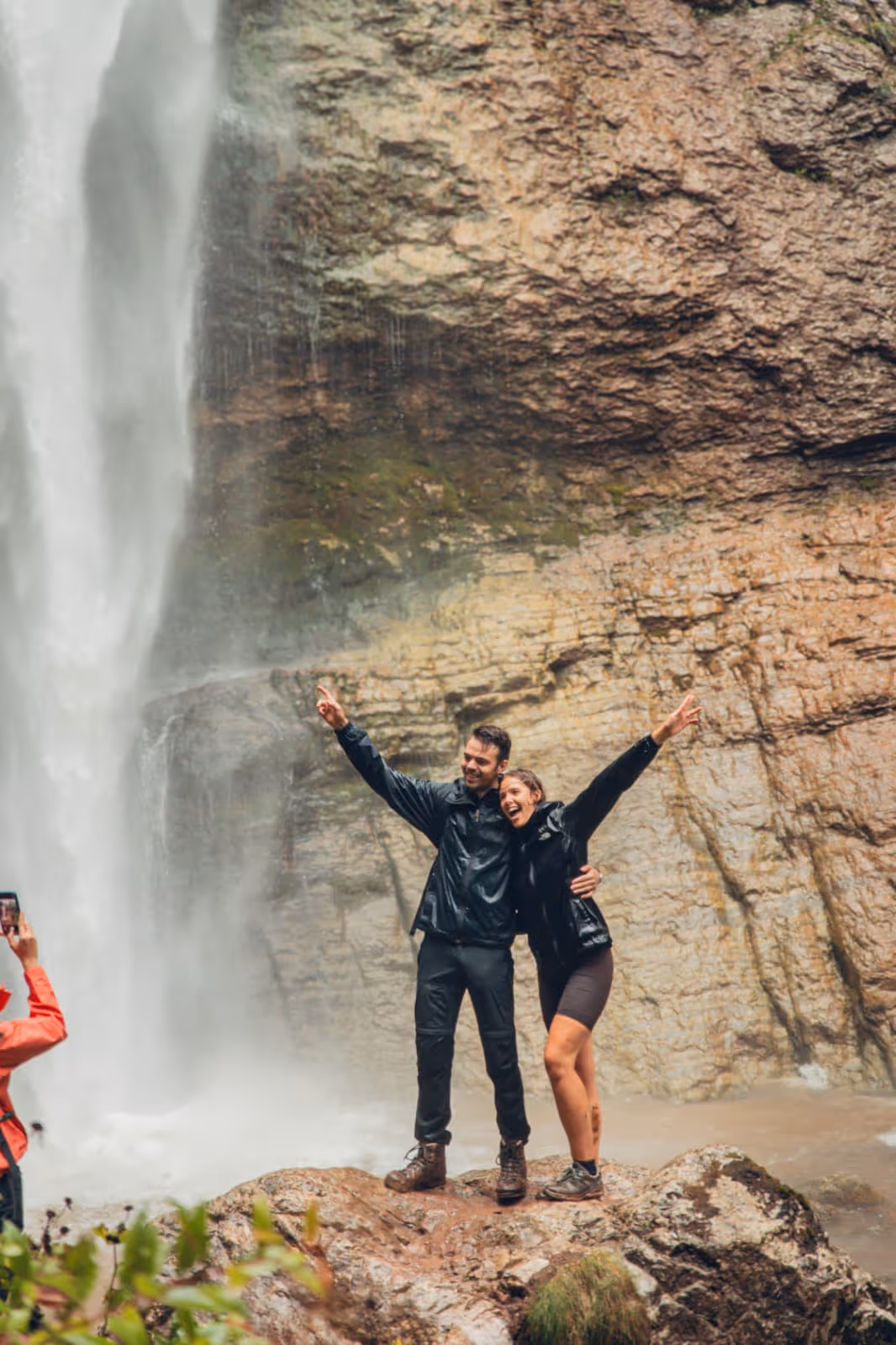 Two hikers at Skakavac Waterfall in Perućica forest, guided hiking tour Sutjeska National Park Bosnia Herzegovina