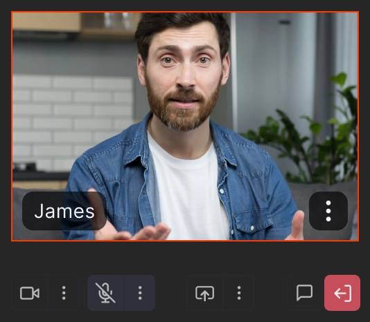 Man with beard and denim shirt speaking on a video call interface.