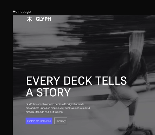 Modern minimalist living room with a sleek dark gray sofa against a green paneled wall, accompanied by plants and a side table.