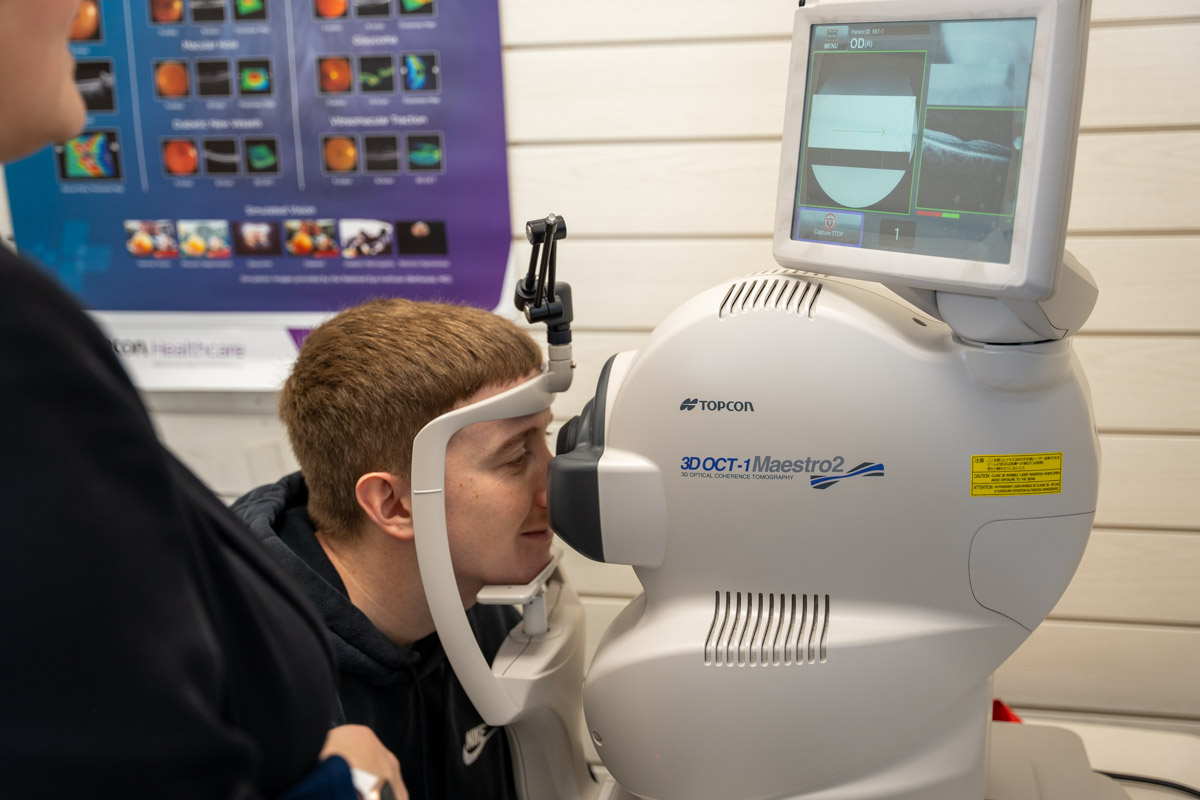 Optician conducting eye test on patient at Makerfield Eye Centre